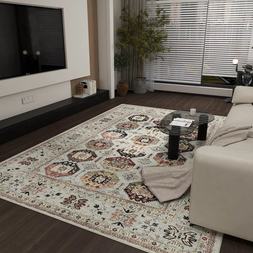 Load image 1 in gallery view. A modern living room with the Rust Mosaic - Washable Rug - JRN1036, a light-colored sofa with a throw, glass coffee table, wall-mounted TV, plant by the window, and floor-to-ceiling blinds letting in natural light.