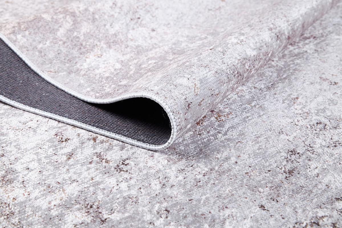 Close-up of Rustic Trails - Washable Rug - JR1736 (Custom Size) in textured gray-anthracite, with one corner folded to show its dark backing—durable for high-traffic spaces and easy to clean as a washable rug.