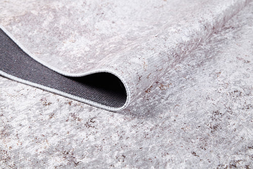 Load image 1 in gallery view. Close-up of Rustic Trails - Washable Rug - JR1736 (Custom Size) in textured gray-anthracite, with one corner folded to show its dark backing—durable for high-traffic spaces and easy to clean as a washable rug.