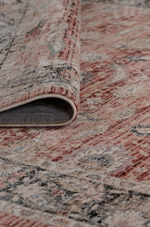 Load image 1 in gallery view. A close-up of the Rustic Bloom - Area Rug - APX2961 in red and beige muted tones, featuring a subtle floral motif and one corner folded to show the texture and underside of this Persian vintage-inspired area rug.