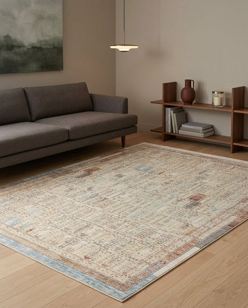 Load image 1 in gallery view. Beige and blue distressed traditional rug with a faded geometric pattern, styled in a modern living room.
