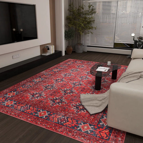 Bild 1 in Galerieansicht laden. A modern living room featuring the Scarlet Charm - Washable Rug - JRN1032, perfect for high-traffic areas, a light sofa with a beige throw, black oval coffee table, wall-mounted TV, and a potted plant beside window blinds.
