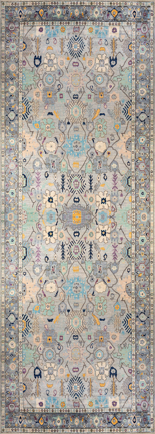 Load image 1 in gallery view. The Seraphix Pastel Bordered Washable Rug - LCC3011 features intricate symmetrical floral and geometric patterns in pastel blue, yellow, and cream with a detailed repeating border, ideal for high-traffic spaces.