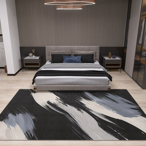 Load image 1 in gallery view. A modern bedroom with a gray upholstered bed, black and white bedding, nightstands, and the Shadow Flow - Washable Rug - JRS011 in black, white, and gray on light wood floors—ideal for high-traffic areas. A circular ceiling light is above the bed.