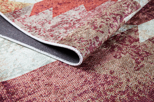 Bild 1 in Galerieansicht laden. A close-up of the Simplistic Artistry - Washable Rug - JR1647 (Custom Size) reveals its red, beige, and gray pattern with one corner lifted to show the texture, thickness, and washable underside—perfect for high-traffic areas.