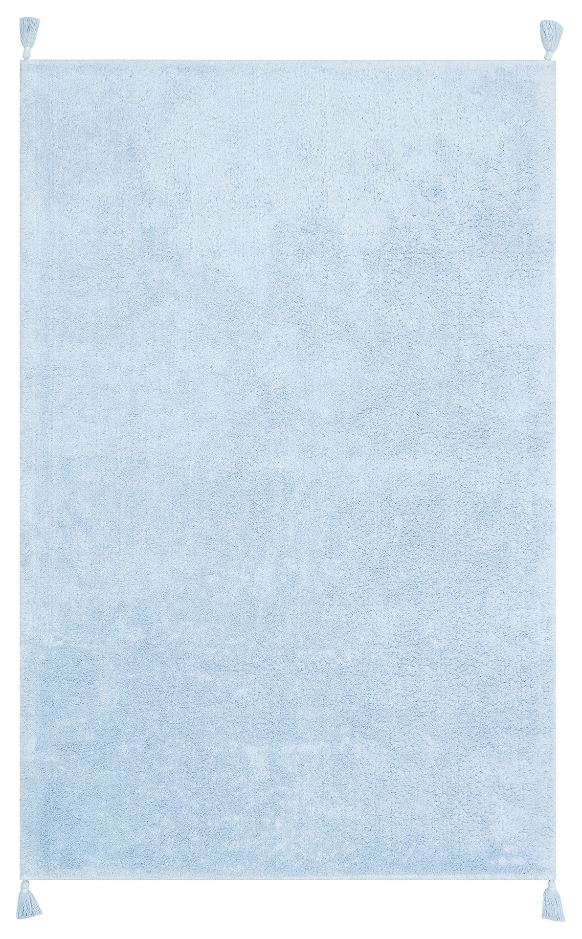 The Sky Nap - Washable Shaggy - CBNPLAIN is a soft blue cotton shaggy rug with a gentle texture and small corner tassels, shown against a white background.