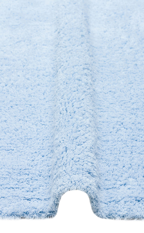 Load image 1 in gallery view. Close-up of the Sky Nap - Washable Shaggy - CBNPLAIN, a soft blue rug with a textured, fluffy surface and center contour to fit around your toilet base. This washable rug adds comfort and style to any bathroom.