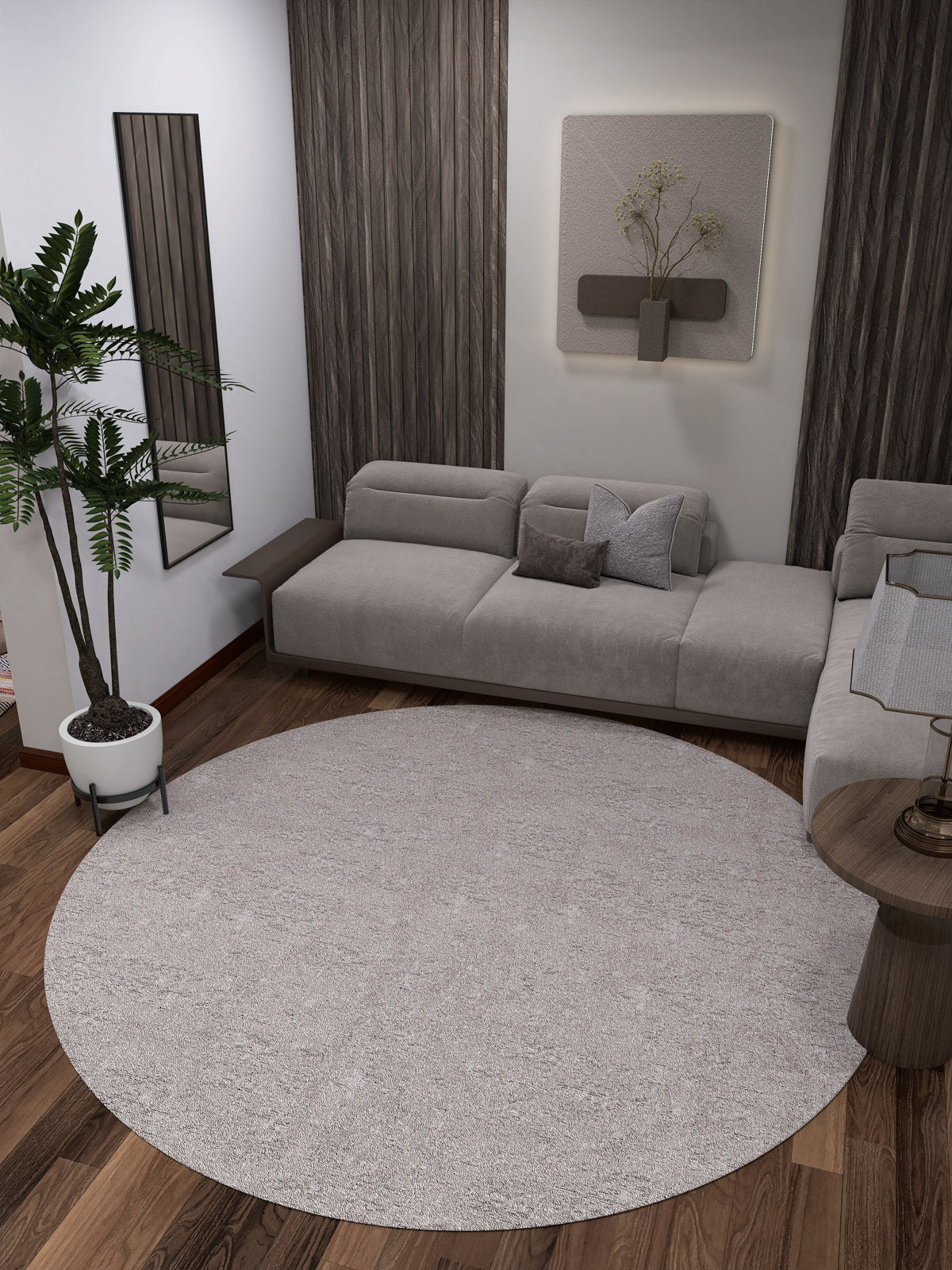 Modern living room with a gray sectional sofa, wood floors, wall art, vertical panels, small side table, mirror, potted plant, and the Slate Charm - Washable Rug - JR1740 (Custom Size) in cream and beige—ideal for high-traffic areas.