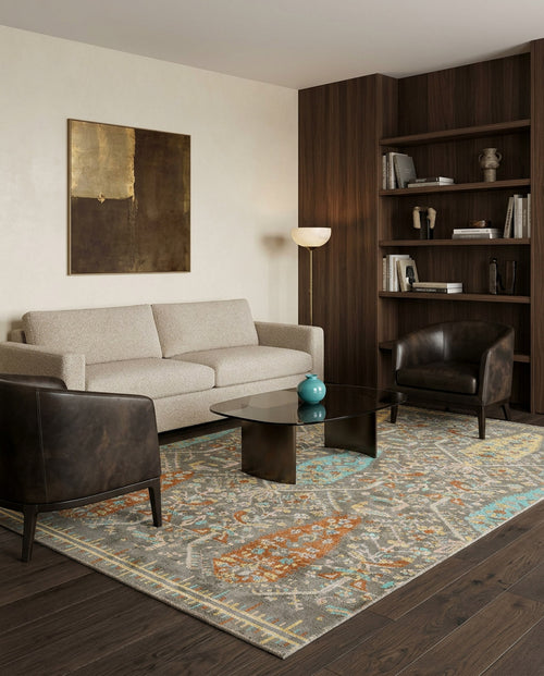 Load image 1 in gallery view. Grey traditional rug with orange and teal floral medallion patterns, styled in a modern living room.