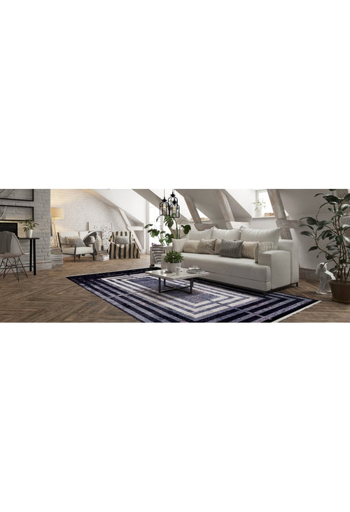 Load image 1 in gallery view. A modern loft living room features a white sofa, neutral cushions, a glass coffee table, and the Sophisticated and Chic - Washable Rug - JR1409. Potted plants, large windows, and exposed wooden beams create an airy, charming space.