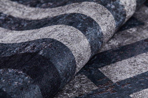 Load image 1 in gallery view. A close-up of the Sophisticated and Chic - Washable Rug - JR1409 (Custom Size) shows its textured black surface with wavy gray stripes—durable for high-traffic areas and easy to maintain thanks to its washable design.