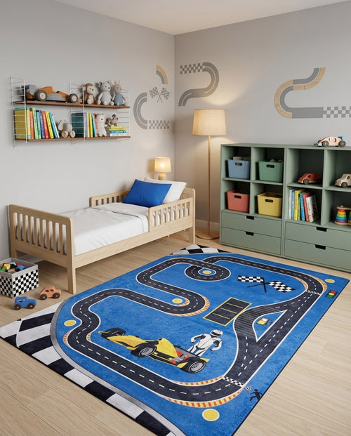 Load image 1 in gallery view. Blue rug with a race track pattern, yellow race car, and checkered borders, styled in a child's bedroom.