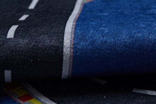 Load image 1 in gallery view. A close-up of the Speedway Sprouts - Machine-Washable Rug JRC068 (Custom Size), featuring a printed curved road with dashed white lines and colorful borders on dark blue and black, ideal for high-traffic areas.