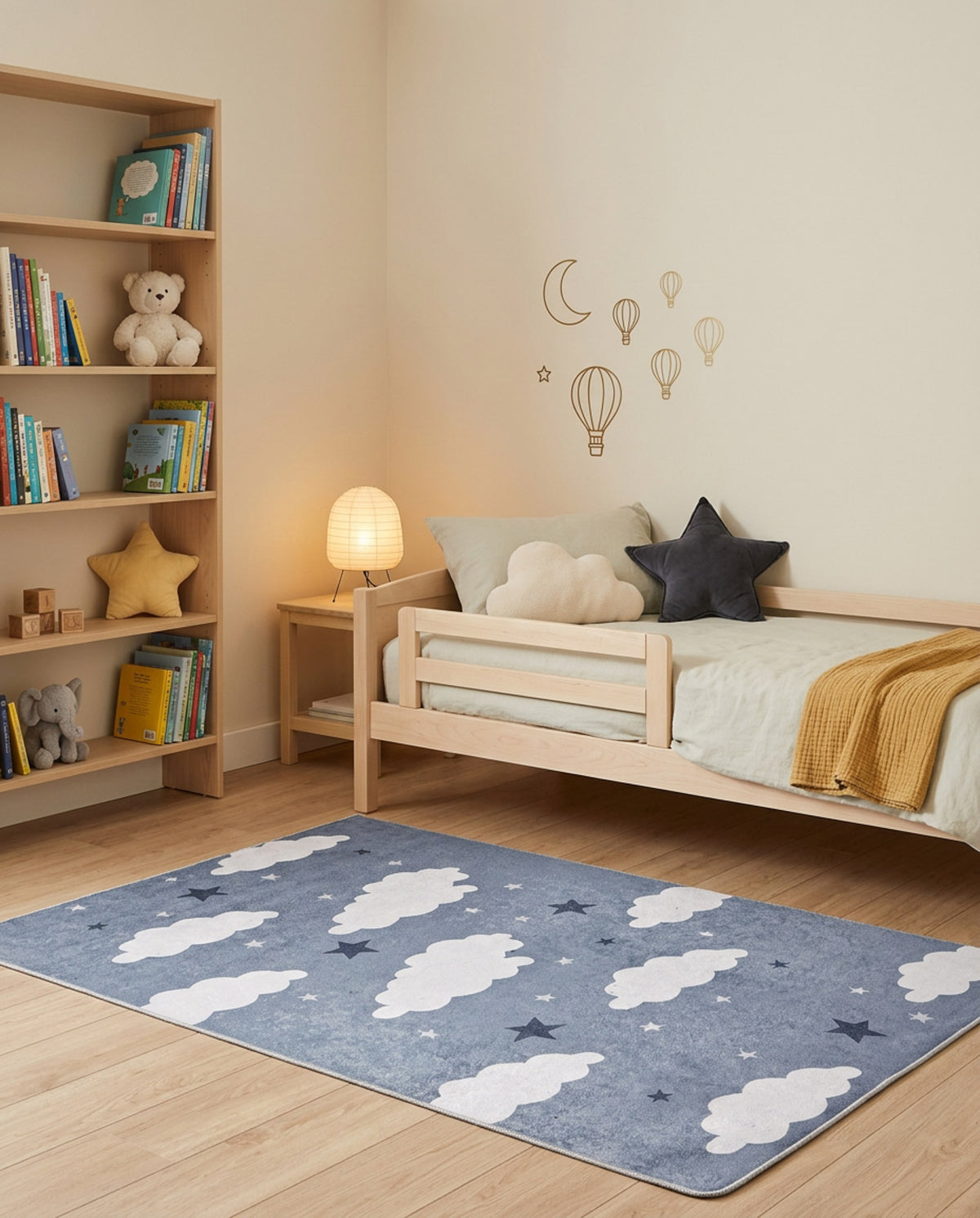 Blue rug with white clouds and dark blue stars, styled in a child's bedroom.
