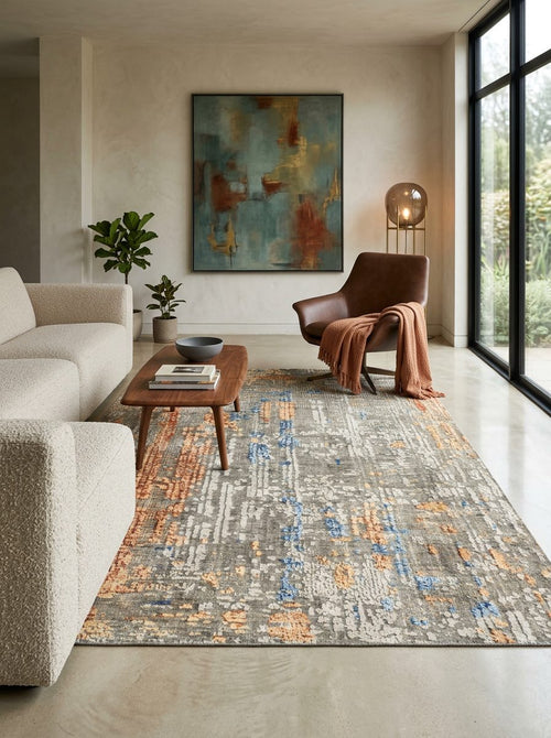 Load image 1 in gallery view. Grey, blue, and orange abstract distressed rug in a modern living room setting.