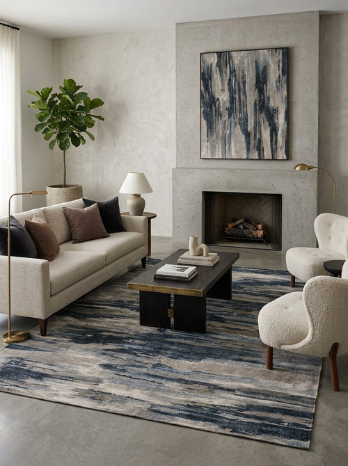 Load image 1 in gallery view. Blue, grey, and beige abstract horizontal striped rug in a modern living room with a concrete fireplace.
