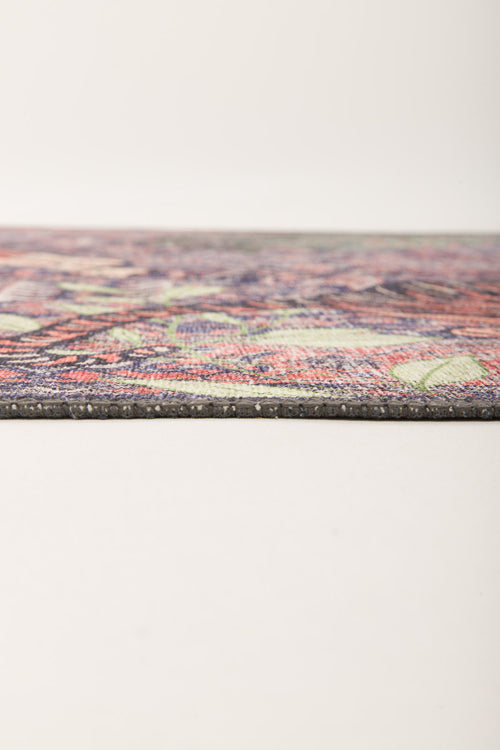 Bild 1 in Galerieansicht laden. A close-up side view of the Stormstripe Echo - Washable Rug - JR0046 reveals its slim profile, blue tone, and detailed multicolored pattern on a plain light background. The rug lies flat, showcasing its modern texture and contemporary design.