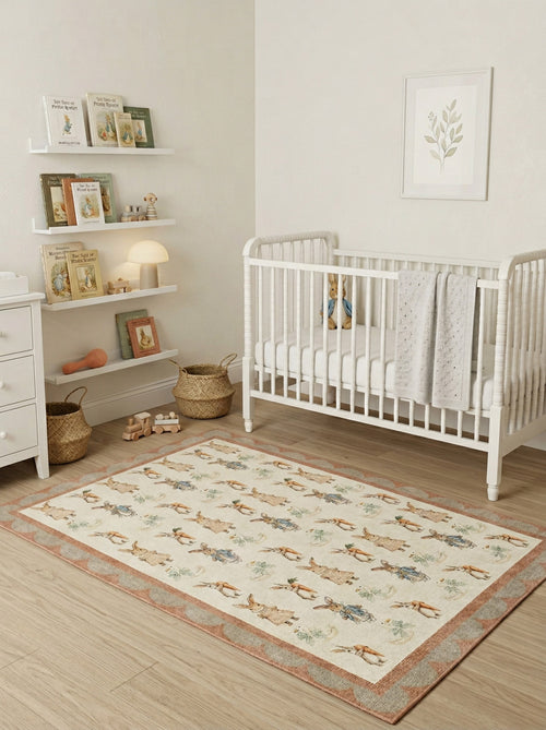 Load image 1 in gallery view. Cream rug with a Peter Rabbit character pattern and scalloped border, styled in a nursery with a white crib.