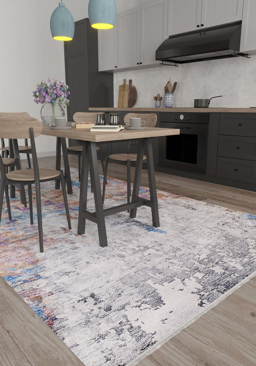 Load image 1 in gallery view. Modern kitchen with a light wood dining set sits on the Striking Statements - Washable Rug - JR786 (Custom Size). Pendant lights hang above, with flowers, coffee mugs, and books on the table. Black cabinets and oven line the back wall.