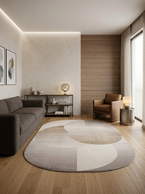 Load image 1 in gallery view. Oval rug with overlapping beige and grey geometric circles, styled in a modern living room.