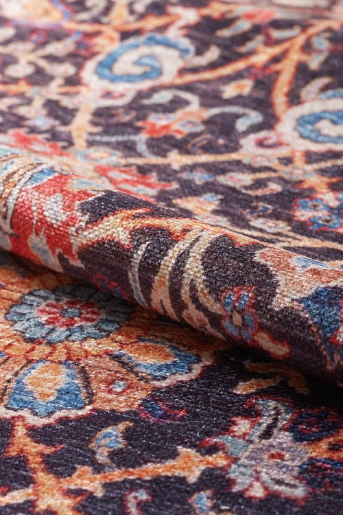 Load image 1 in gallery view. A close-up of the Sylvanor Colorful Washable Rug - LCC3017, showing its detailed blue, red, yellow, and cream floral patterns on a dark background. The visible texture makes it perfect for high-traffic areas.