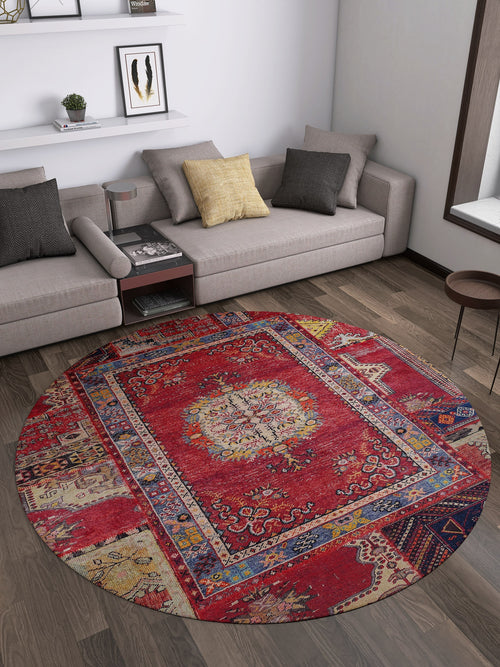 Bild 1 in Galerieansicht laden. A modern living room with a gray sectional, neutral cushions, a Tapestry Tango - Washable Rug - JR313 in red on wooden floors, a small round side table, and wall art above the sofa. Light from a large window makes it ideal for high-traffic areas.
