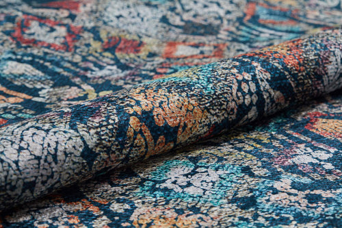 Load image 1 in gallery view. A close-up of the Tarnished Elegance - Washable Rug - JR1095 (Custom Size), showcasing its intricate multicolored abstract pattern in blue, orange, red, and cream. The detailed weave is visible—durable and ideal for high-traffic areas.