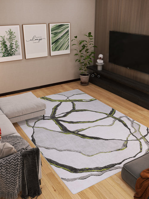 Load image 1 in gallery view. A modern living room featuring a light gray sectional, wooden floors, a TV on a low dark cabinet, potted plant, framed botanical art, and the Tattered Grace - Washable Rug - JRN49 (Custom Size) with green and black lines.