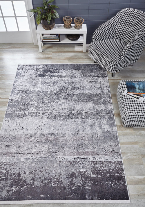 Load image 1 in gallery view. A modern living room featuring the Techno Flux - Washable Rug - JR1814 (Custom Size) in gray-anthracite, a black-and-white houndstooth armchair, matching ottoman with a book, and a white console table with plants against a blue wall. Ideal for busy spaces.