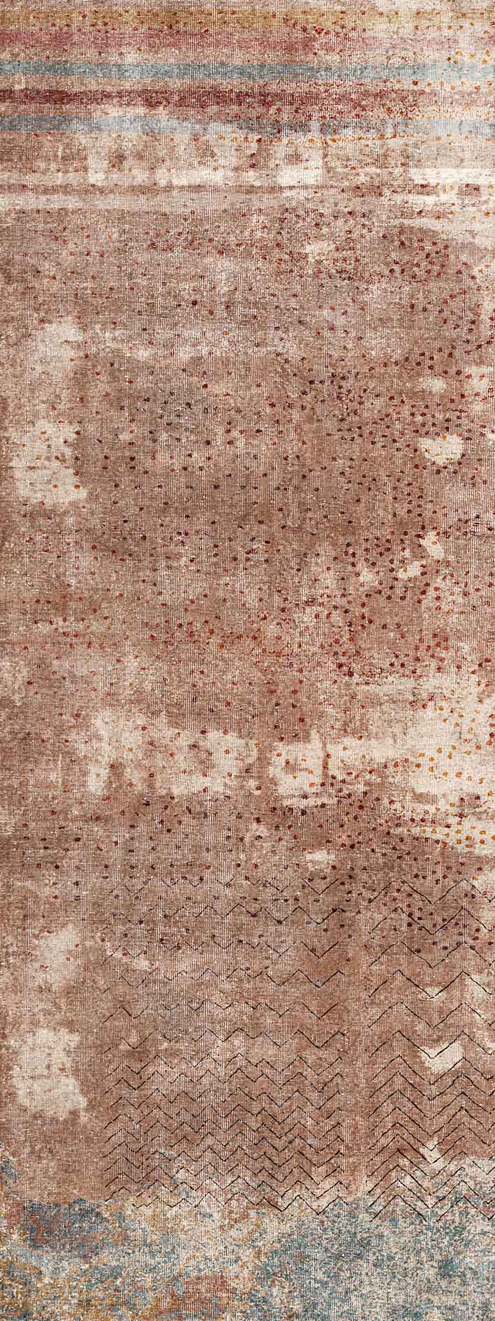 Terracotta rug with a distressed texture, dotted pattern, chevron accents, and horizontal striped borders.