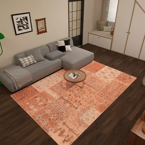 Load image 1 in gallery view. A cozy living room features a gray sectional sofa, round wooden coffee table, and the Terracotta Patch - Washable Rug - JRN1037 (Custom Size) on dark wood flooring. Modern pillows and décor create an inviting feel with this easy-care rug as the centerpiece.