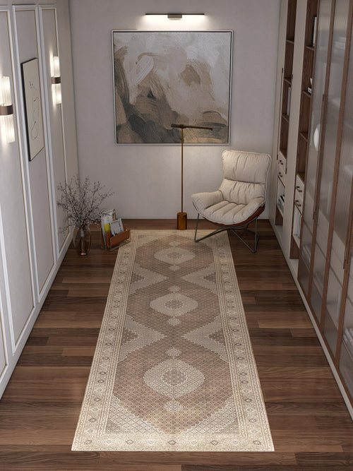 Load image 1 in gallery view. A modern hallway with wooden floors, the Timeless Arabesque - Washable Rug - JRN1002 featuring a subtle medallion design, abstract wall art, a tall floor lamp, a cushioned chair, a glass vase with branches, and built-in shelves along one wall.