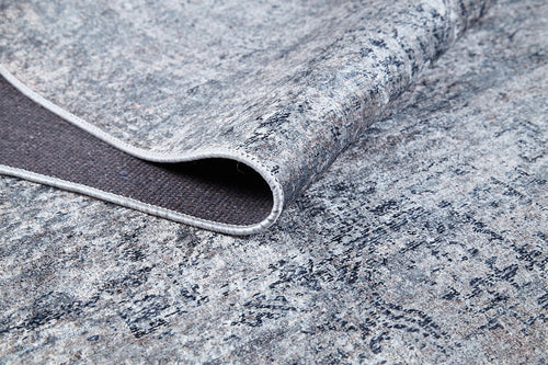 Load image 1 in gallery view. A close-up of the Timeless Scrollwork - Washable Rug - JR1774 (Custom Size) shows its textured gray and blue abstract pattern with a corner folded to display the dark, non-slip backing—perfect for high-traffic areas.