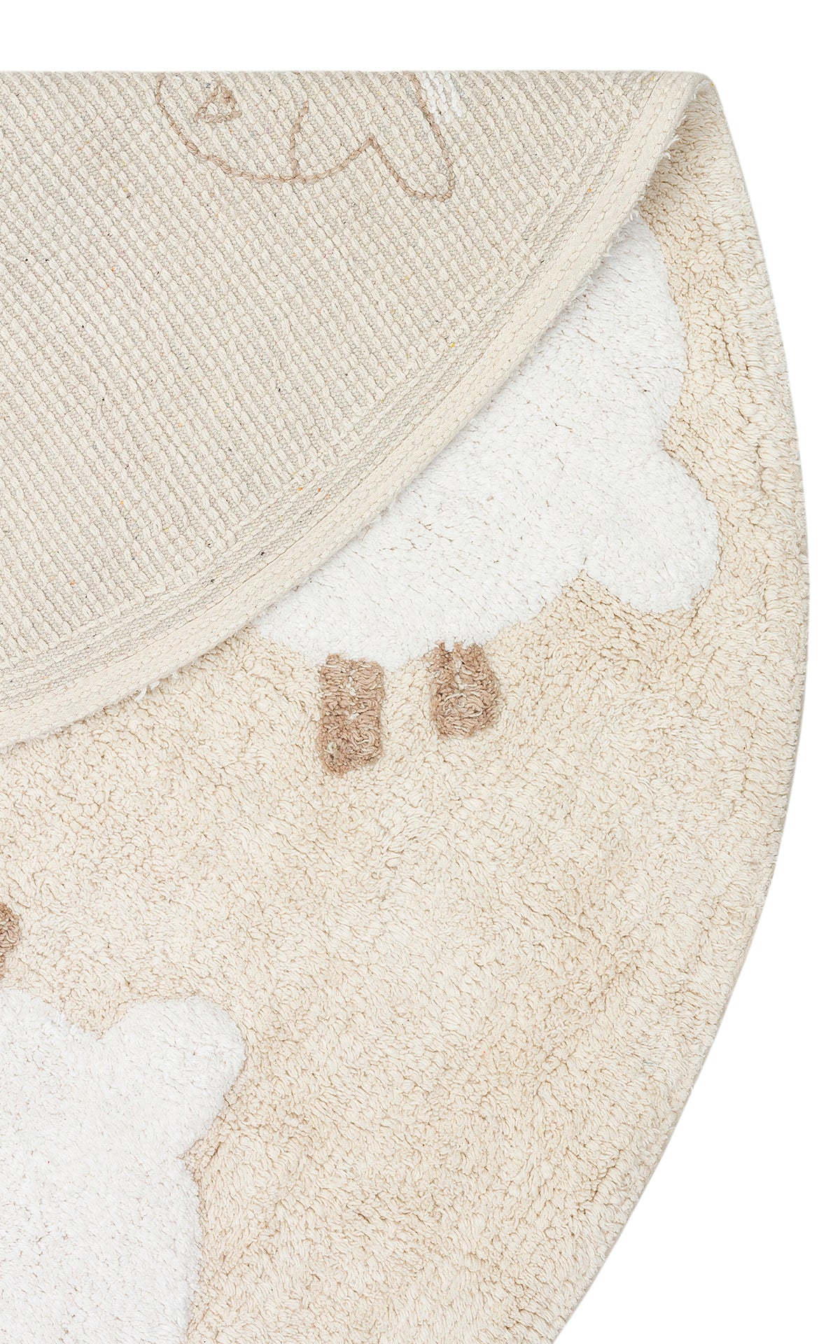 A close-up of the Tiny Motion - Washable Shaggy - CBN11 round beige and white cotton rug featuring a sheep design, partially folded to display both the playful front pattern and its textured backing.