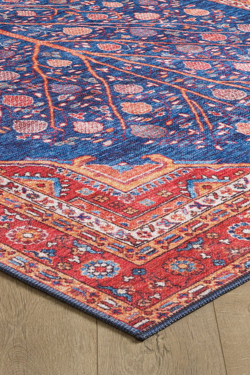 Load image 1 in gallery view. A close-up of the Tree of Plenty Red Blue Washable Rug (LCC3031, Custom Size) shows its vibrant geometric border and floral-vine patterns—ideal for allergy-sensitive homes and durable in high-traffic spaces on light wood floors.
