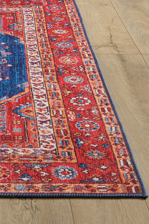 Load image 1 in gallery view. A close-up of the Tree of Plenty Red Blue Washable Rug - LCC3031 (Custom Size), featuring vibrant geometric patterns in red, blue, yellow, and white on a light wood floor—ideal for high-traffic or allergy-sensitive homes.