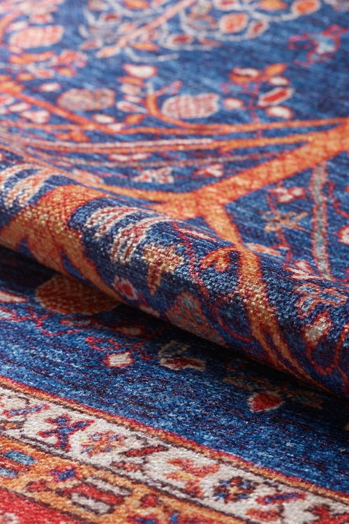 Load image 1 in gallery view. A close-up of the Tree of Plenty Red Blue Washable Rug (LCC3031, Custom Size) showcases its vibrant floral and geometric patterns in blue, orange, and red—perfect for high-traffic spaces and easy to clean.