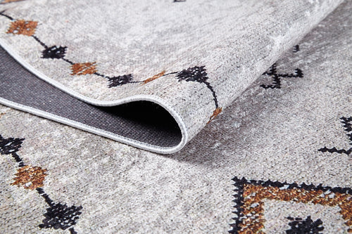 Load image 1 in gallery view. A close-up of the Tribal Tassel - Washable Rug - JR1683 (Custom Size) highlights its textured, patterned surface and underside. With a light gray base and black/brown geometric motifs, it’s ideal for allergy-sensitive homes seeking style and convenience.