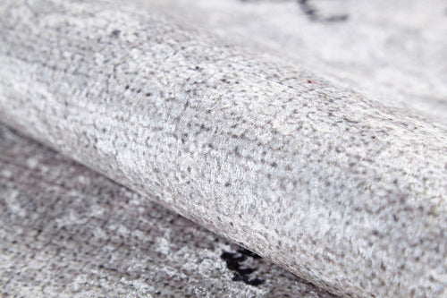Load image 1 in gallery view. Close-up of the Tribal Tassel - Washable Rug - JR1683 (Custom Size) in light grey, featuring a soft, dense fiber surface with subtle speckles and shading. Allergy-sensitive material resembles plush cream and beige rugs, shown partially rolled.
