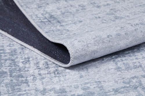 Load image 1 in gallery view. A close-up of the Twilight Sky - Washable Rug - JR856 (Custom Size) in light gray-anthracite, showing a folded corner that reveals the dark underside—ideal for high-traffic areas and easily washable for convenience.