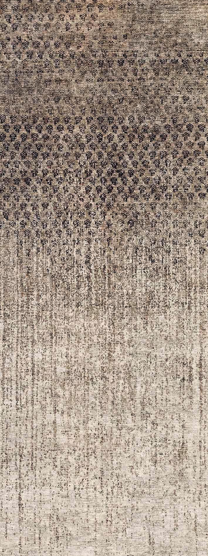 Charcoal and beige rug with a distressed, gradient ombre pattern transitioning from dark geometric motifs to a light fade.