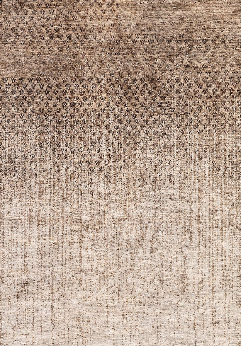 Brown and beige rug with a distressed, speckled ombre pattern fading from dark to light.