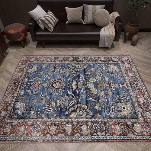 Load image 1 in gallery view. Blue and red traditional Persian-style rug with intricate floral patterns, styled in a living room.