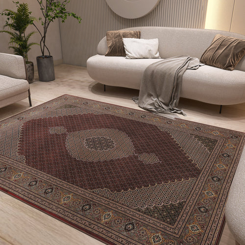 Load image 1 in gallery view. Deep red traditional rug with a central medallion and ornate border, styled in a modern living room.