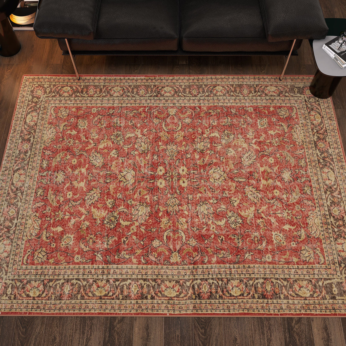 Red and beige traditional rug with a distressed floral medallion pattern, styled in a modern living room.