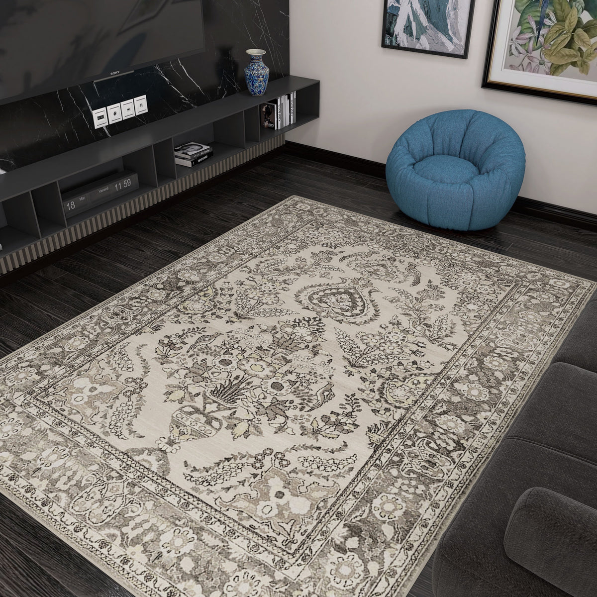 A living room with dark wood floors, the Velvet Mosaic - Washable Rug - JRN1004 (Custom Size) in beige patterns, a blue bean bag chair, a low media console with a vase, and framed artwork creates a cozy vibe for traditional interiors.