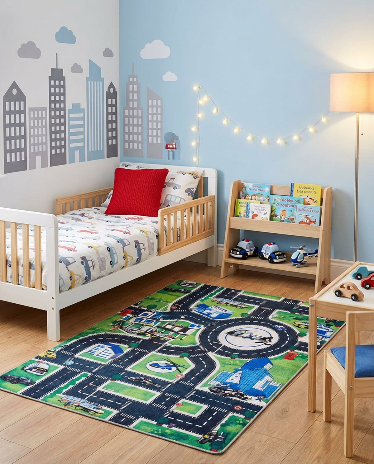 Green and blue rug featuring a city street map with roads and buildings, styled in a child's bedroom.