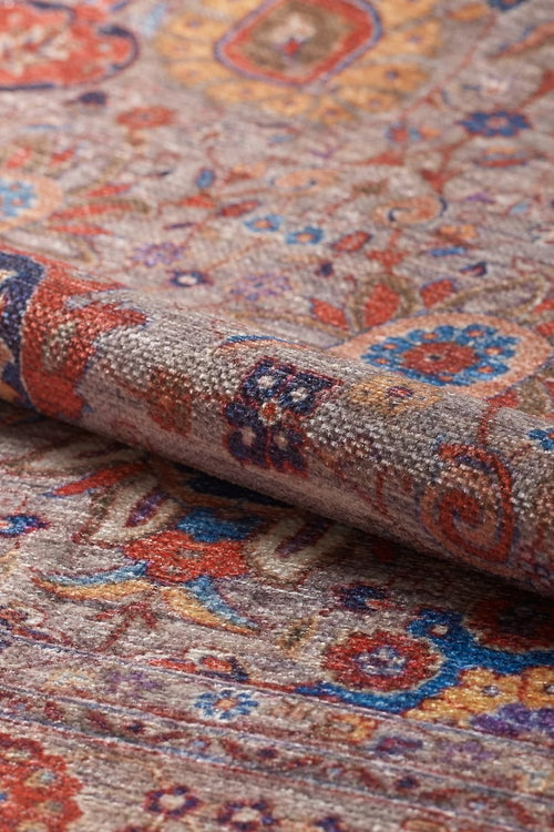 Bild 1 in Galerieansicht laden. A close-up of the Velorio Floral Washable Rug - LCC3006 shows its intricate floral and geometric pattern in red, blue, orange, and beige—durable and perfect for high-traffic areas.