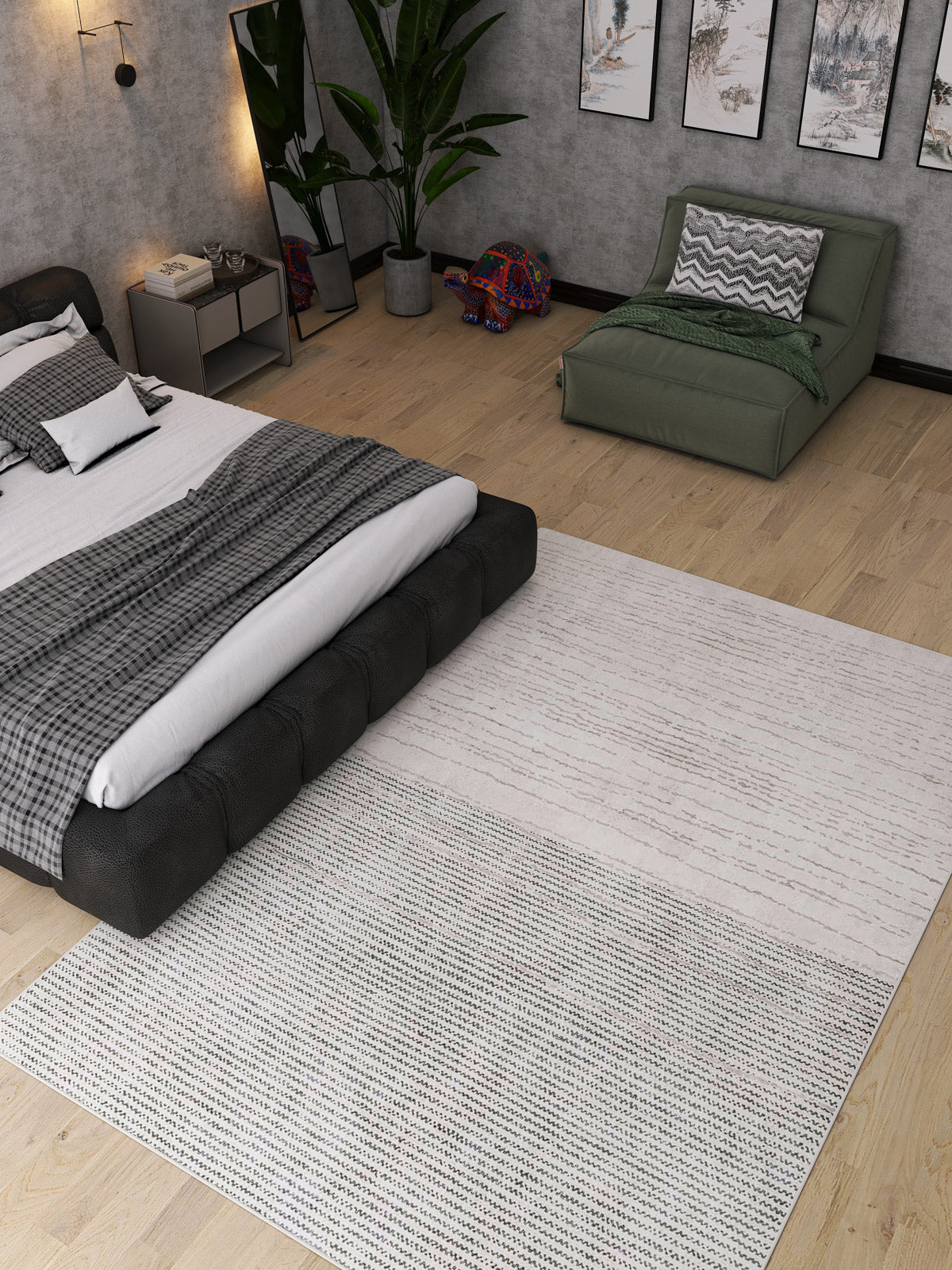 A modern bedroom with a low black bed, gray bedding, the Velvet Echo Washable Rug (JRN25)—ideal for high-traffic areas—green lounge chair with chevron pillow, potted plant, wall art, wooden floor, and a colorful elephant statue.