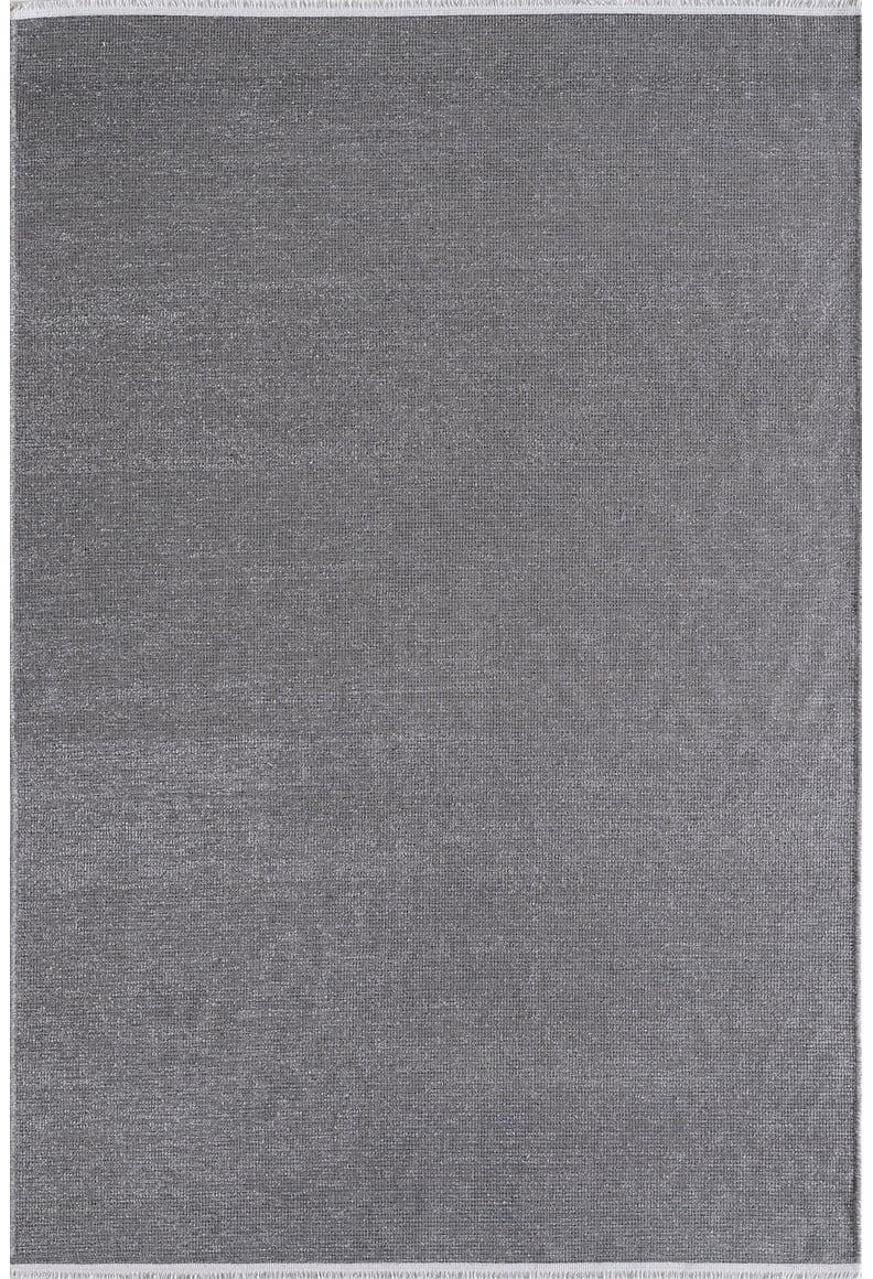 The Velvet Touch Dark Gray Area Rug - PST004 features a large rectangular shape, solid gray color, subtle textured surface, and neatly finished edges—ideal for adding minimalist style to any room.